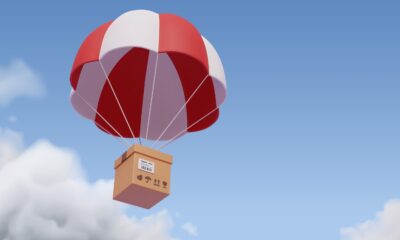 A package strung onto a white and red parachute (Shutterstock)