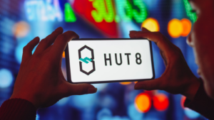 In this photo illustration, the Hut 8 Mining logo is displayed on a smartphone screen