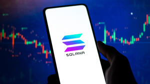 Solana logo stock image on phone screen. Solana price forecast.